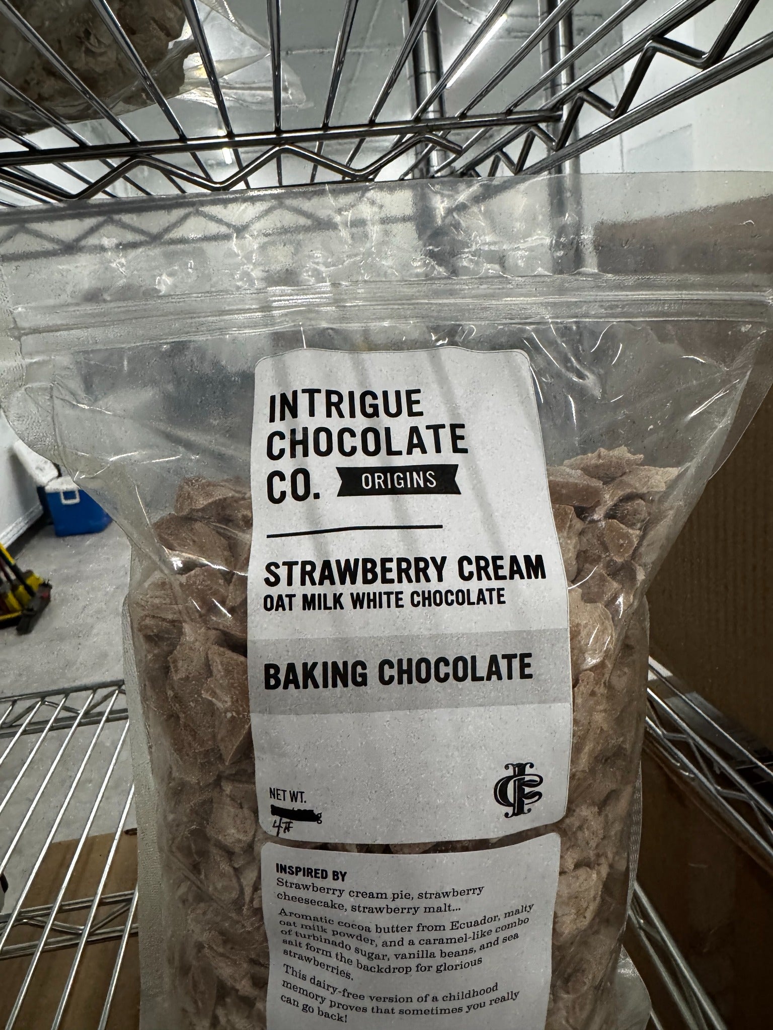 Intrigue Chocolate Co. bulk Strawberry Cream oat milk white baking chocolate in a labeled four-pound bag.