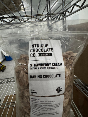 Intrigue Chocolate Co. bulk Strawberry Cream oat milk white baking chocolate in a labeled four-pound bag.
